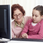 Grandma with grandaughter at computer