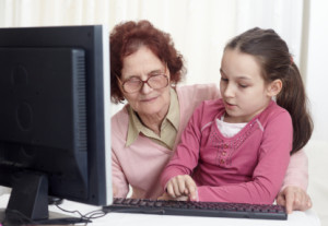 Grandma with grandaughter at computer