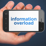 Information concept: hand holding smartphone with word Information Overload on display. Mobile smart phone on Blue background, 3d render