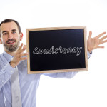 Consistency - Young businessman with blackboard - isolated on white