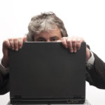Man hide behind computer close up