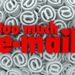 The words Too Much E-Mail on a background of email at or @ symbols and signs to illustrate being flooded with unwanted messages or spam in your mail inbox