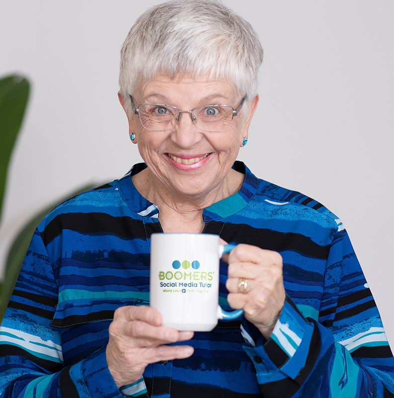 Joyce Feustel holding her logo mug